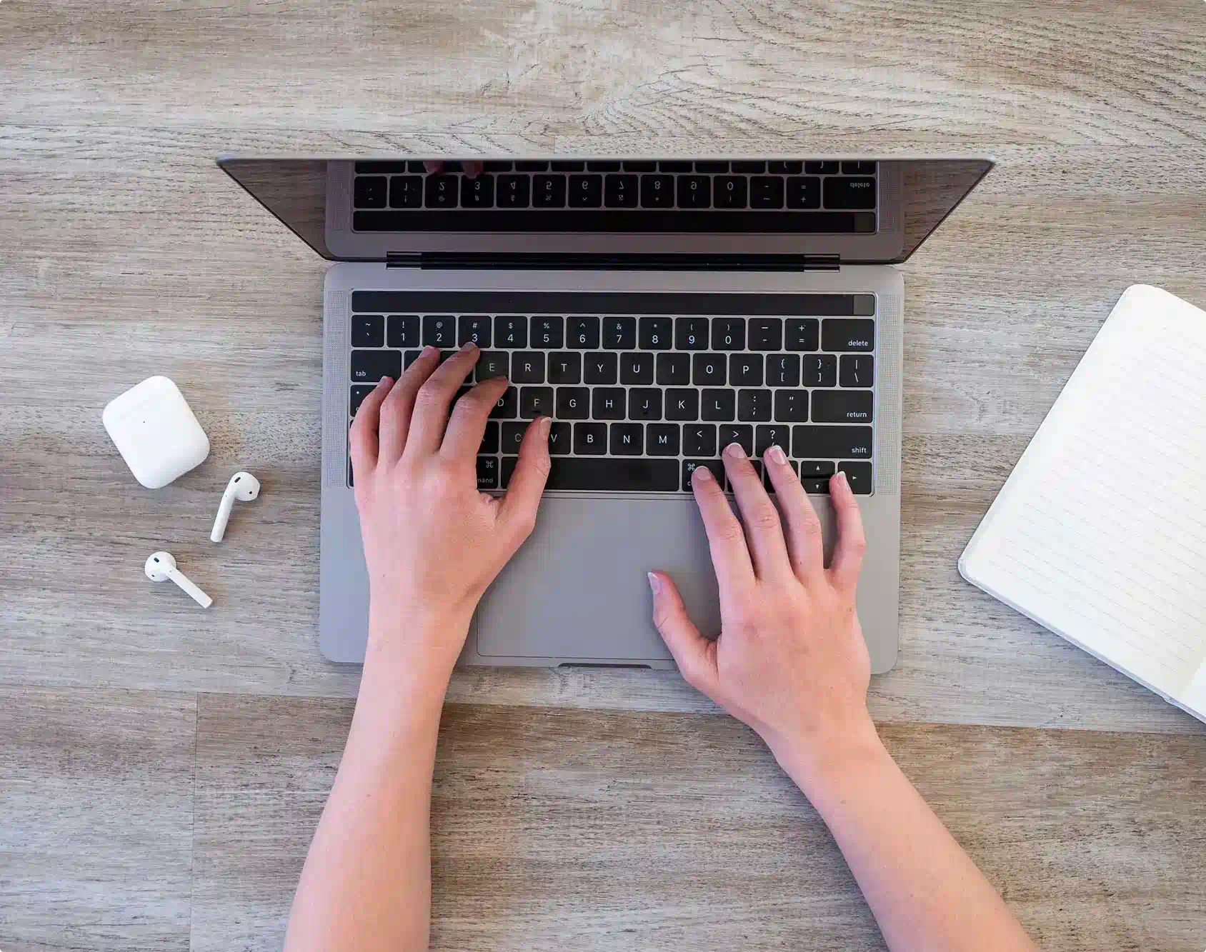 Hands typing on computer